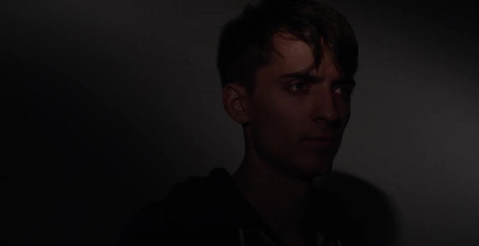 Light slowly illuminating a man and then fading back to black