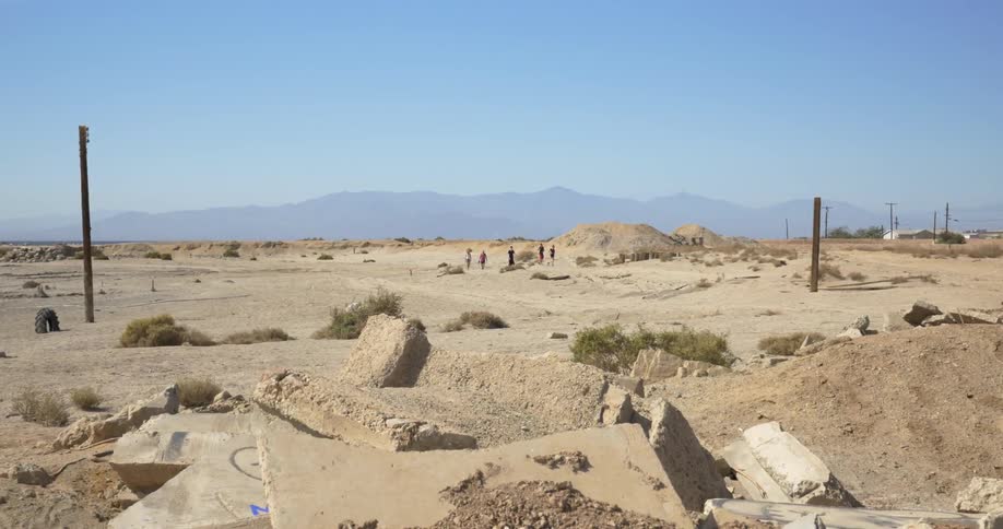 People walking off in a desert
