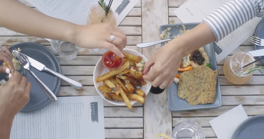 People sit at a table eating appetizers
