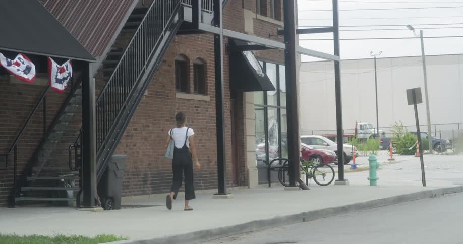 A woman is walking down a sidewalk