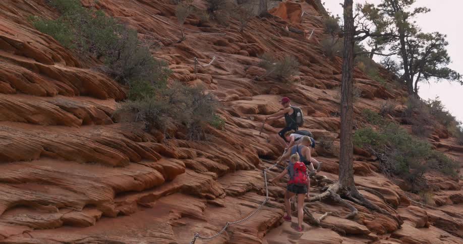 People hiking up a rocky hill