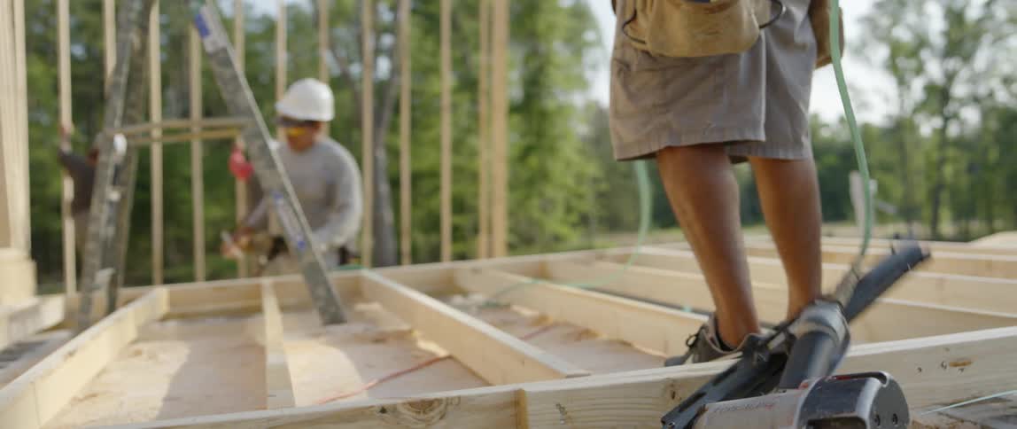A group of construction workers are working on a building