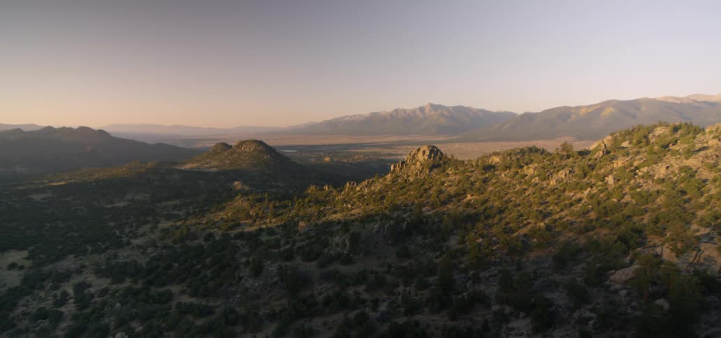 A mountain range is shown at sunrise