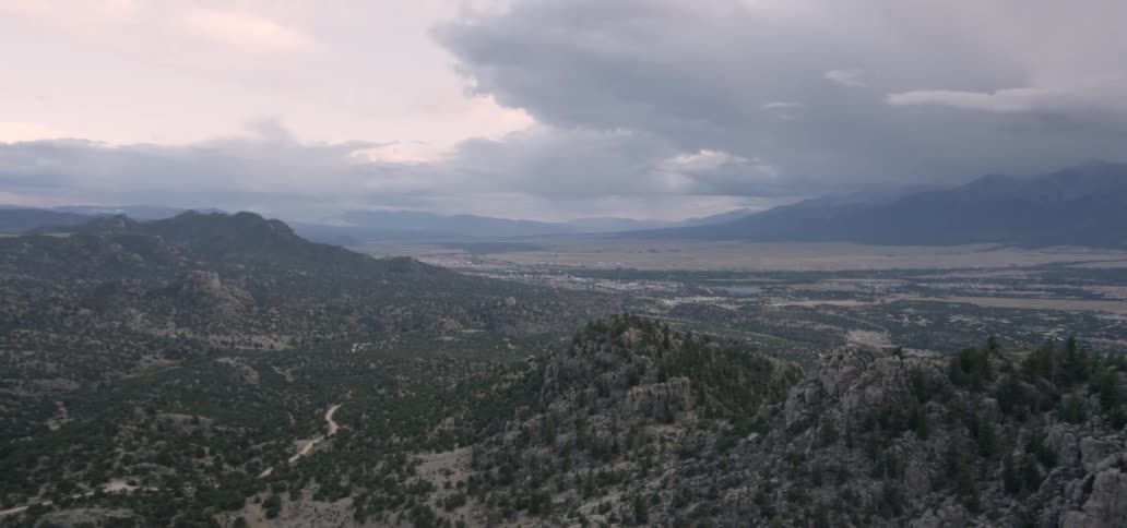 The mountains are lined with trees at the bottom
