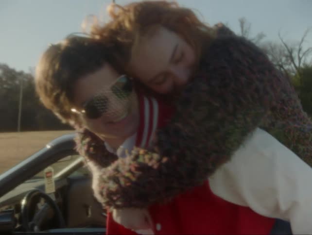 A woman rides piggyback on a man's back