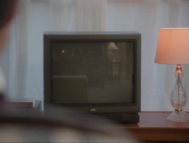 Person points remote control at unresponsive television