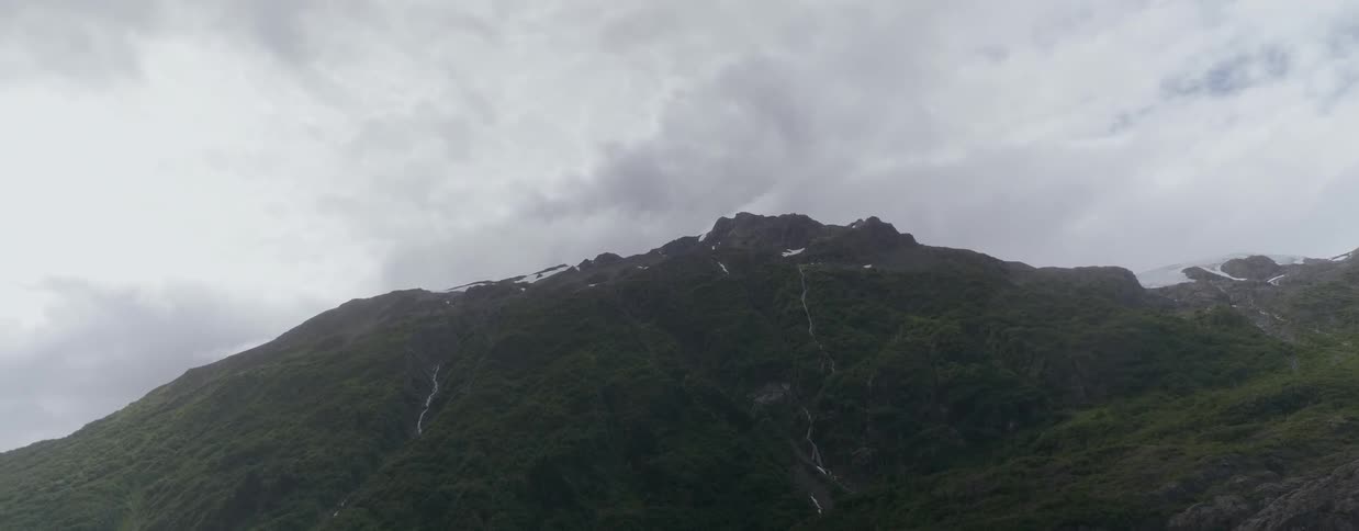 Clouds float over a mountain peak