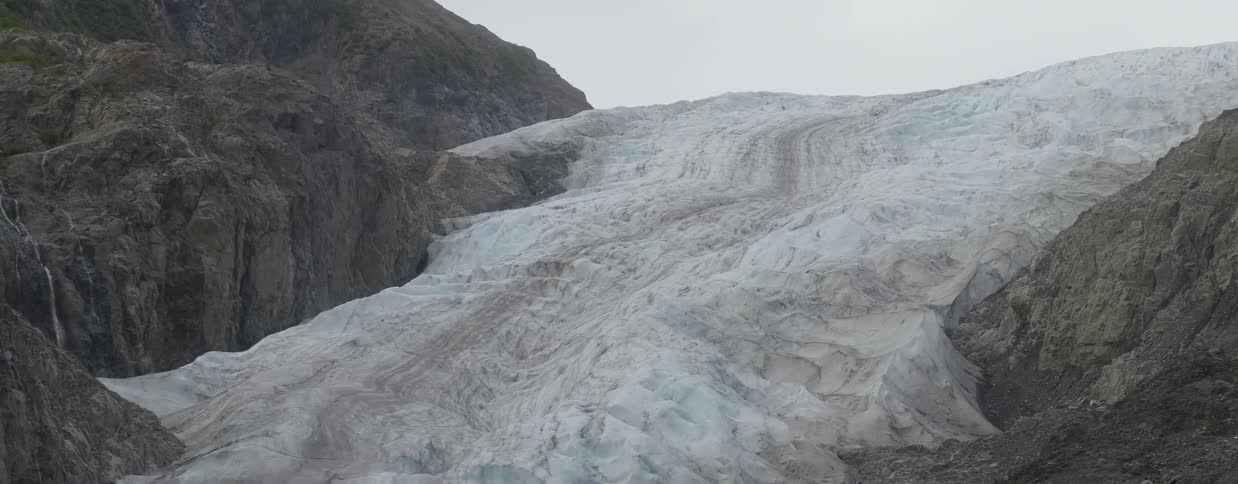 Layers of ice and snow cover a rocky slope