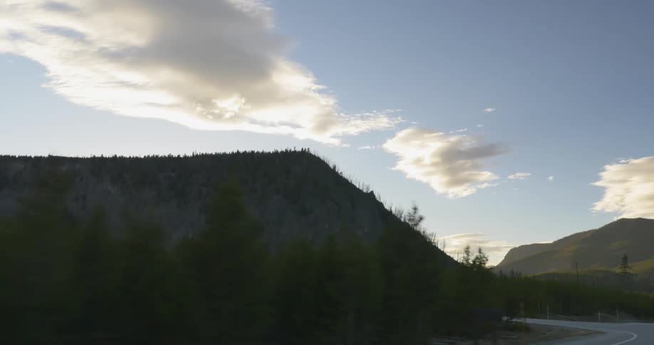A mountain as seen from a moving vehicle