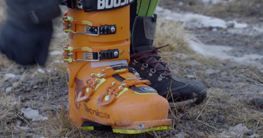 A skier latches their ski boots