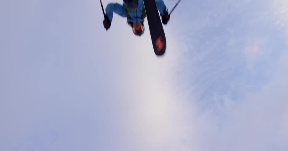 Person jumps over camera while skiing