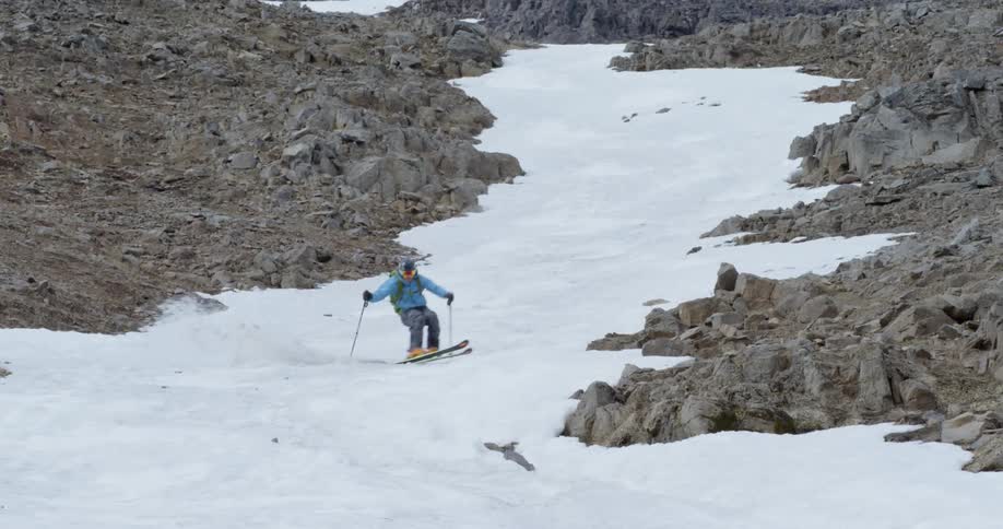 A skier flies down the mountain