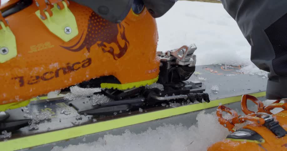 A person steps down in to ski binding