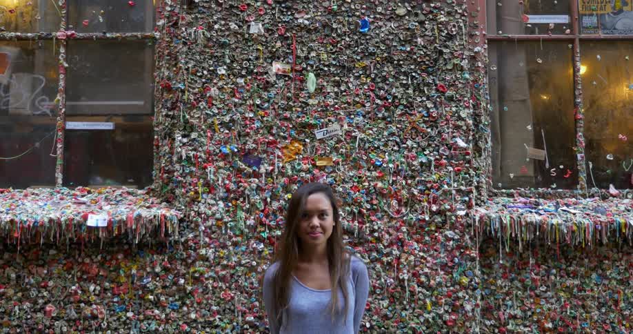 Woman standing against a very colorful wall