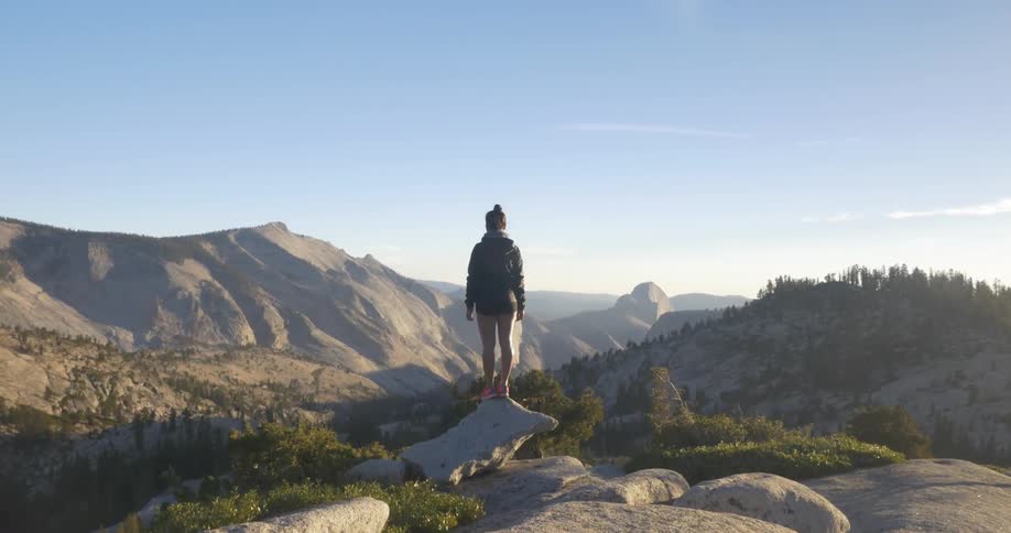 A woman overlooks mountains