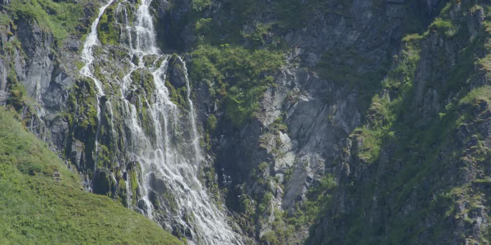 A waterfall on the side of a mountain