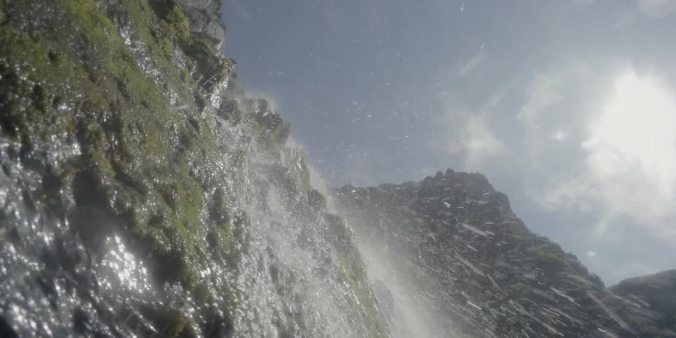 Water streams over a mountain cliff