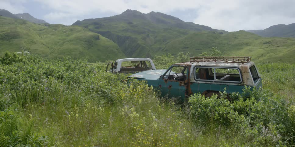 Rusted out suv on a grassy mountain