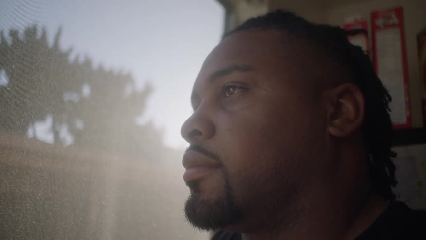 A man looks out of a window