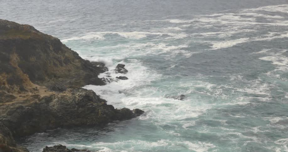 Ocean waves crash into the land