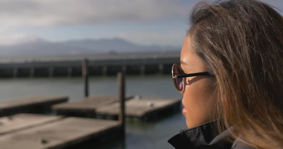 A person in sunglasses looking at a dock
