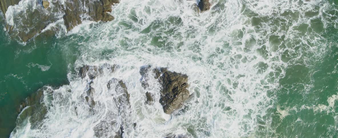 Ocean waves crash over rocks
