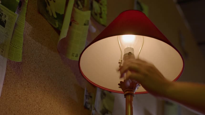 Someone is turning on a lamp