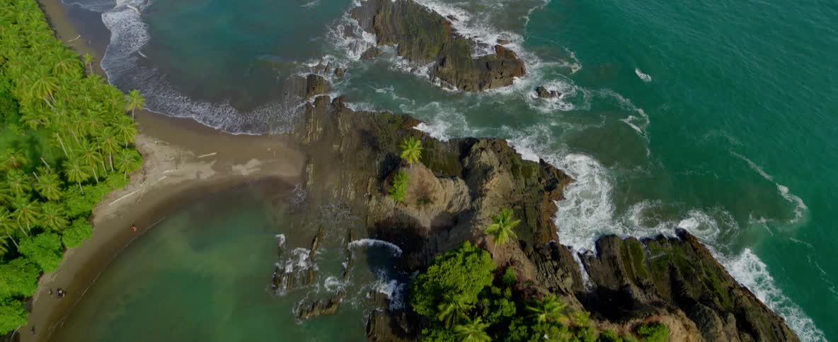 Ocean waves crash into rocks