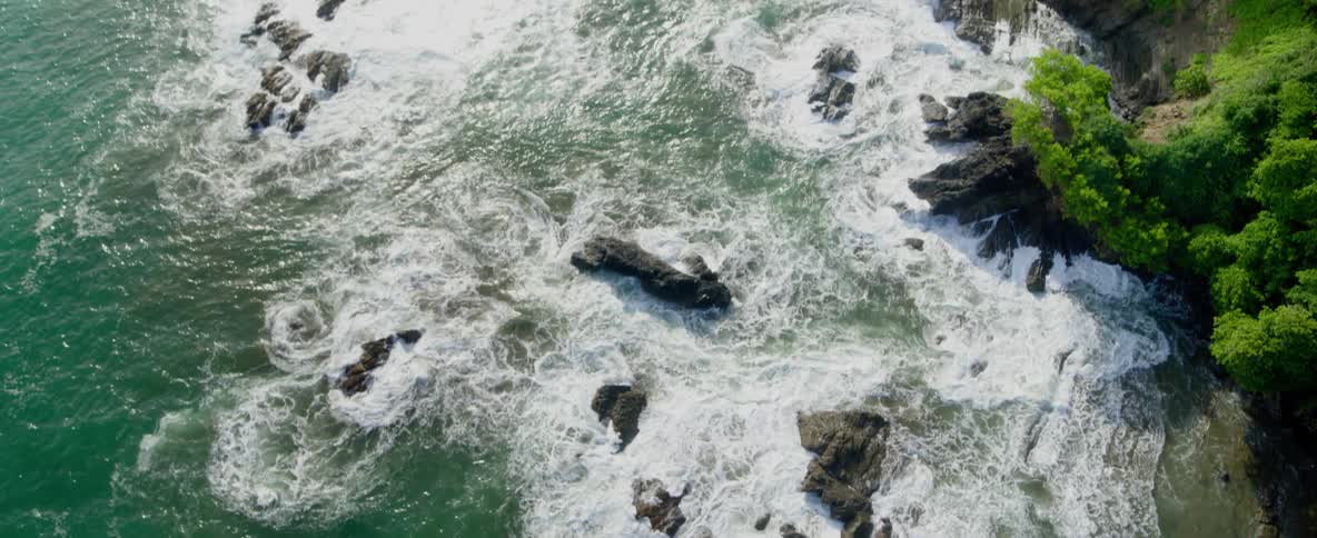 Ocean waves crash into a rocky shoreline
