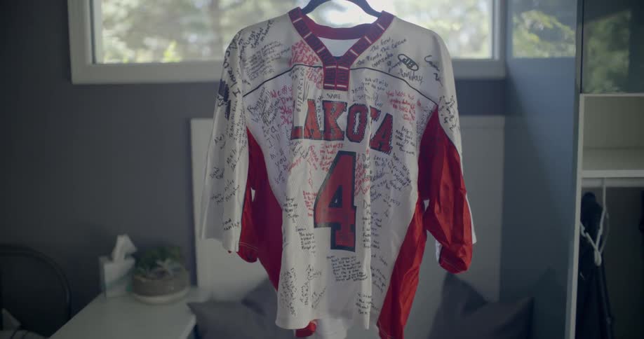 An autographed jersey hanging in a room