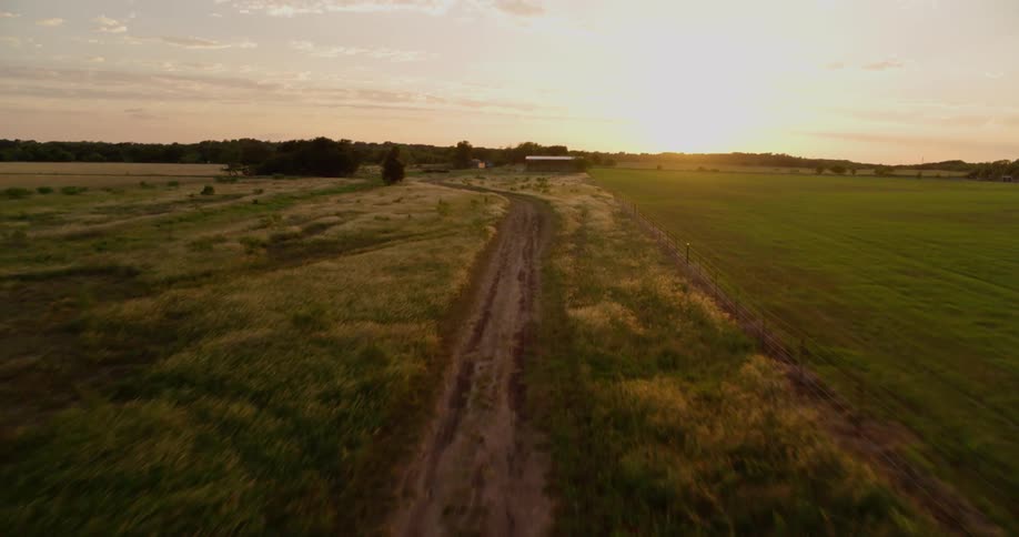 The sun sets over rural fields