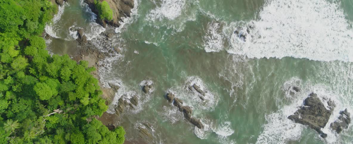 Water flows onto the rocky shore