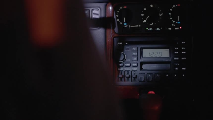 Person adjust the radio in their car