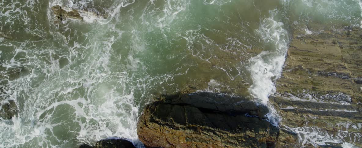 Ocean waves wash over rocks