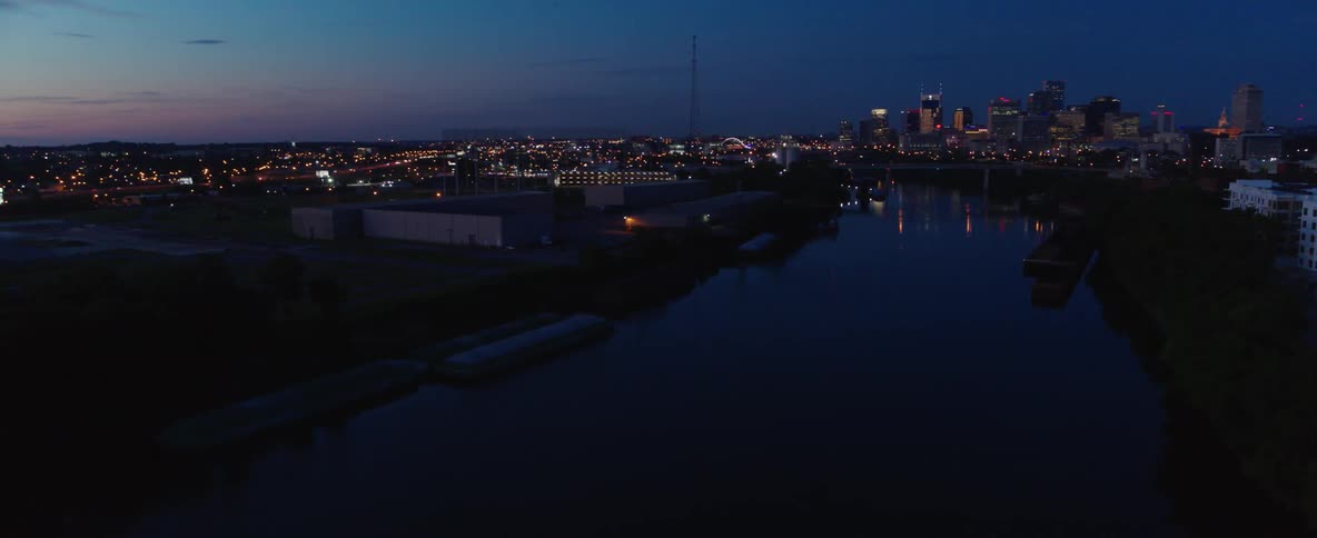 A riverside city after sunset