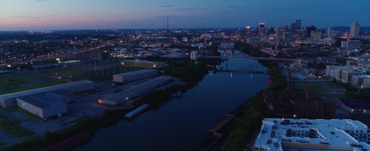 A river flows through a city at dusk