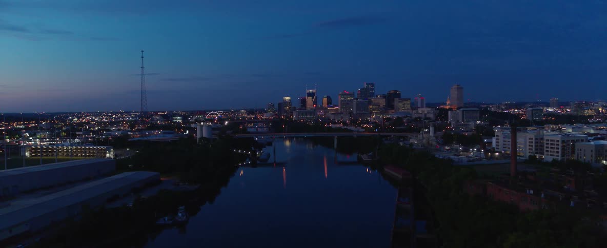 A riverside city after sunset