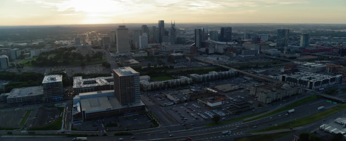 Traffic flows on a freeway in a city at dusk