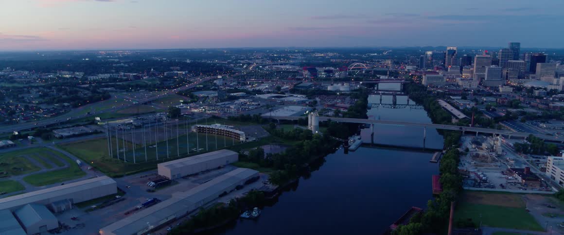 A river flows through a city at dusk