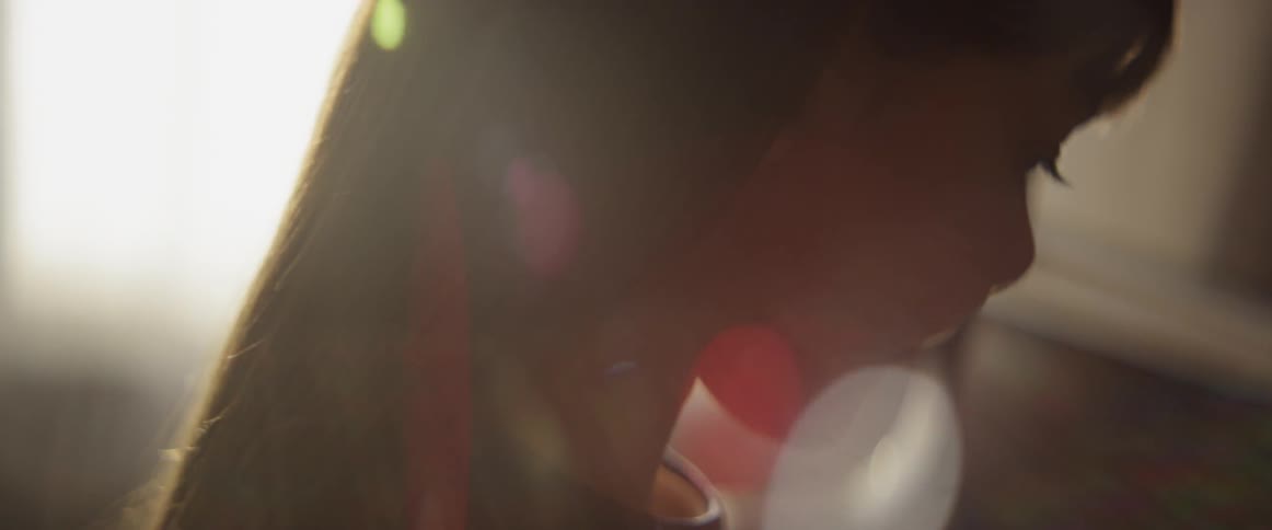 A child is looking down at a piano