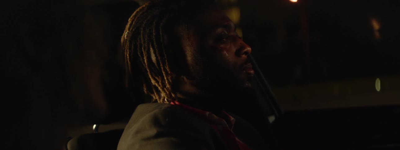 A man sits down at night in his car