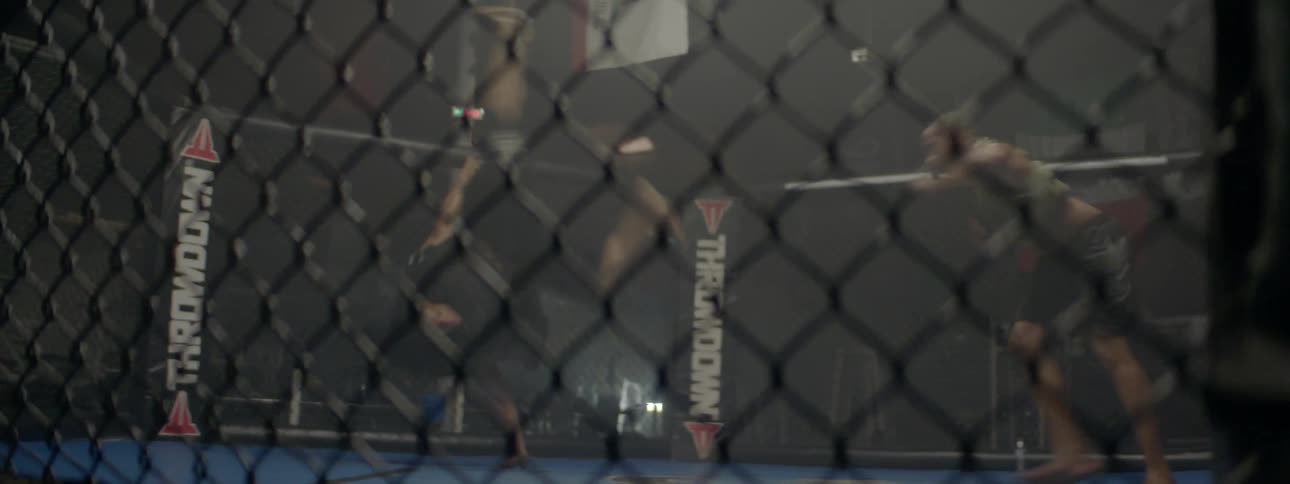 Two men train in an mma ring