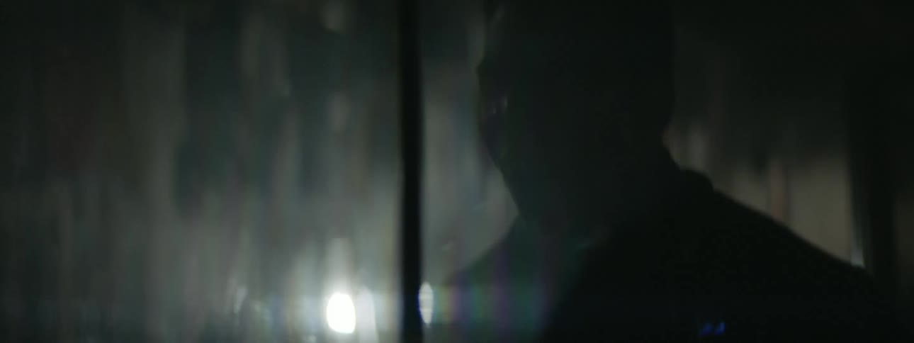 A man screams while looking in a mirror