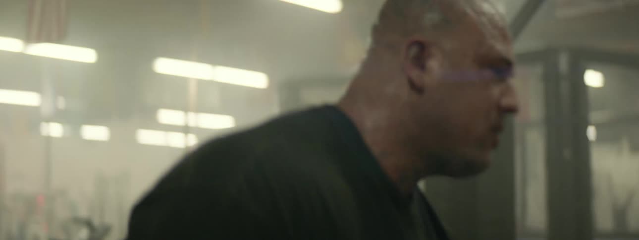 A sweaty man spars in a gym