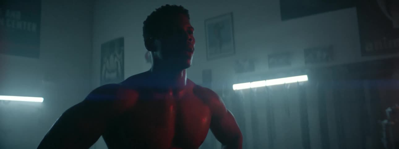A man stands sweating in a gym