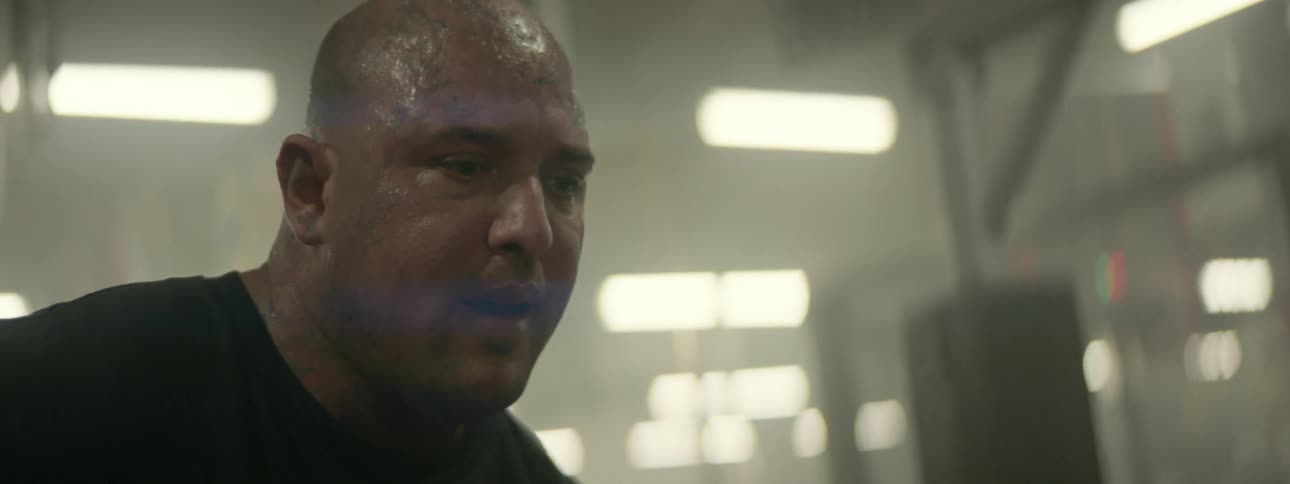 Sweat drips from a man's head while he talks
