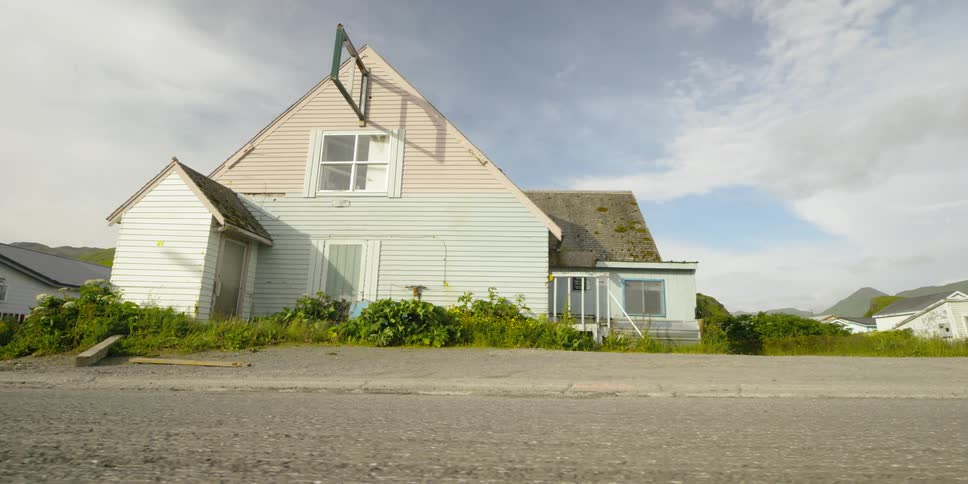 A house with a broken sign