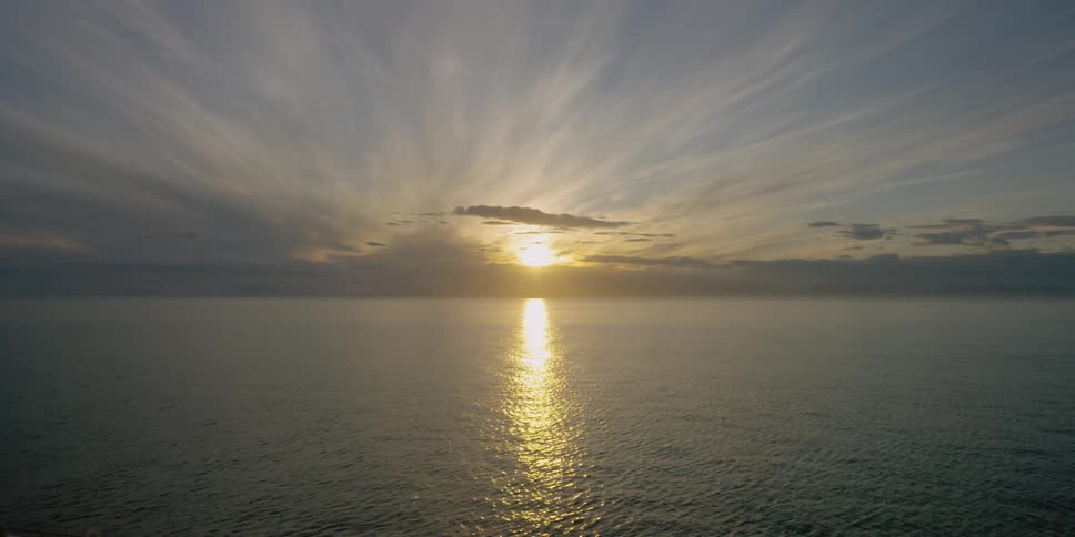The sun sets over rippling ocean water