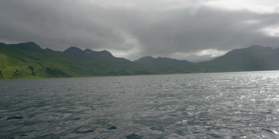 Boat pushing toward mountains