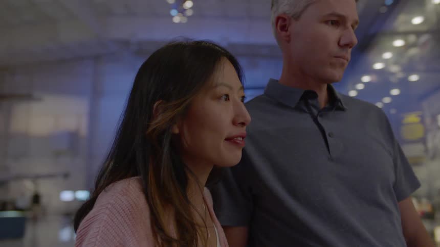 People watch an exhibit in a museum